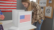 Young woman voting in an indoor united states electoral college room, adorned with american flag.