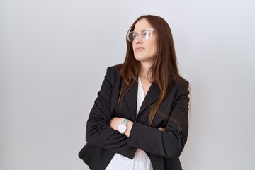 Canvas Print - Beautiful brunette woman wearing business jacket and glasses looking to the side with arms crossed convinced and confident