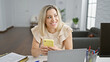 © Krakenimages.com - Young blonde woman business worker using laptop and smartphone at the office