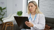 © Krakenimages.com - Young blonde woman doctor writing medical report at the clinic