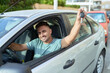 © Krakenimages.com - Young hispanic man smiling confident holding key of new car at street