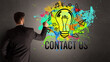 © ra2 studio - businessman drawing colorful light bulb