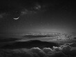 moon over the clouds in a black sky