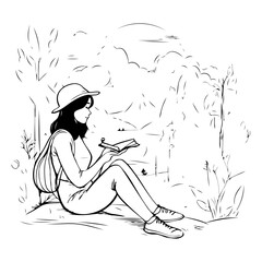 Wall Mural - Young woman sitting in the park and reading a book.