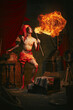 © master1305 - Fire show. Young man in turban breathes fire, displaying dramatic flame burst over dark retro circus backstage background. Concept of circus, theater, performance, show, retro and vintage
