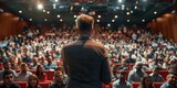 Fototapeta Zachód słońca - Motivational speaker giving a talk on stage to a large audience at a conference. Concept Motivational Speaking, Public Speaking, Conference Presentation, Audience Engagement, Inspirational Talk