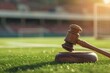 Sports Law and Taxes: Legal Gavel on Sports Stadium Background with Copy Space. Concept Sports Law, Taxes, Legal Issues, Sports Stadium, Gavel