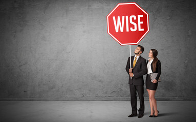 Wall Mural - Young business person holding road sign