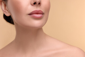 Wall Mural - Woman with beautiful lips on beige background, closeup. Space for text