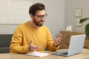 Poster - Man having video chat via laptop at home