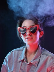 Poster - Young woman wearing sunglasses in smoke on color background