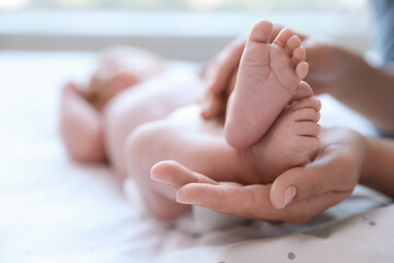 Sticker - Mother and her newborn baby on bed, closeup. Space for text