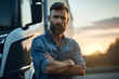 A middle-aged man with a beard with folded arms stands against the background of a truck on the street looking into the camera, shipping and transportation theme
