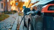 Photo of electric car charging, ecology transportation concept. Autumn. Fall foliage and sustainable travel: Electric car powering up.