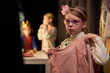 © Seventyfour - Portrait of cute young girl trying on dress costume backstage preparing for school play performance copy space