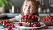  a little girl sitting at a table in front of a cake with raspberries on the top of it.