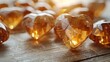  a group of heart shaped crystals sitting on top of a wooden table with sunlight streaming through the top of them.
