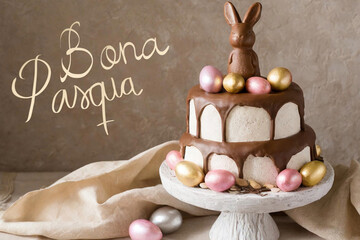 Poster - Happy easter text in catalan with cake with easter eggs and chocolate bunny on top.
