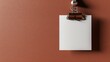 A minimal mockup of a blank white paper sheet hanging on a brown wall with a binder clip. The paper is slightly angled to the right.
