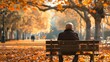 An old man sitting on a bench in a park full of autumn leaves