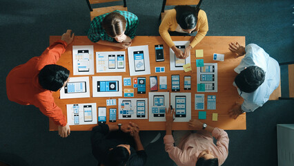 Top view of developer and designer shake hand together at meeting. Software developer handshake and working together with programmer to develop Ux Ui desifn for mobile phone interface. Convocation.