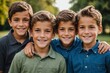 A set of quadruplets brothers smiling for camera in an outside portrait