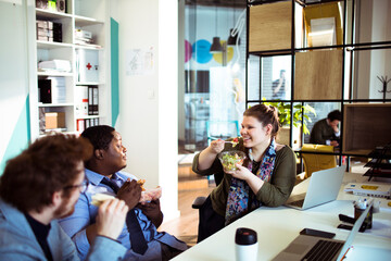 Canvas Print - Diverse young people sharing corporate lunch at the office