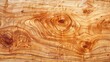 The image is a close-up of a wooden surface with a beautiful grain pattern. The wood has a rich, warm color and a smooth, satiny texture.