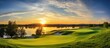 Sunset view of a golf course with a lake in the background