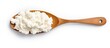 Wooden spoon with cottage cheese, top view