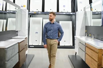 Wall Mural - Man choosing new bathroom furniture at the plumbing shop with lots of sanitary goods