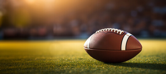 Realistic American football ball lies on the football field. Against the backdrop of the stands with fans