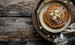 homemade pancakes with honey and pine nuts on rustic wooden background