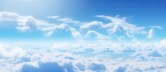 Wall Mural - a natural landscape with a fluid sky full of cumulus clouds in electric blue. the wind gently moves 