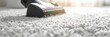 Vacuum cleaner on a white fluffy carpet. Thorough rug cleaning. Vacuuming. Concept of household chores, home hygiene, carpet grooming, and professional cleaning service. Banner. Copy space