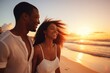 A joyous couple embraces, laughing in the warm glow of a sunset on a sandy beach, epitomizing happiness and love. Joyful Couple Embracing in Golden Sunset Light
