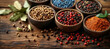 Spices on a wooden background, close-up. Bay leaf, black pepper peas and cardamom. Seasonings and herbs of world cuisines