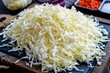 Close-up shot of shredded cabbage piled high on a black cutting board