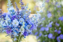 A Picturesque Bouquet Of Lavender And Blue Delphiniums, Capturing The Essence Of A Summer Day