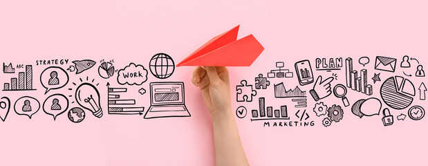 Woman with red paper plane on pink background