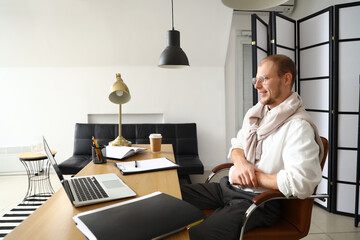 Wall Mural - Male tutor with laptop giving online lesson at home