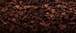 Capture the detailed view of a mound of roasted coffee beans in this image