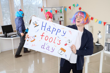 Sticker - Business man with poster celebrating April Fools' Day at office party