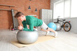 © Pixel-Shot - Sporty young man training with fitball in gym