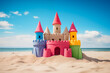 A simple sandcastle rises against the backdrop with colorful flats on the sandy shores of the beach