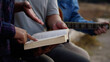 © Thew - Three men read,pray and studied the bible at the park and prayed together. sharing the gospel with a friend. Holy Bible study reading together on Sunday.Studying the Word Of God With Friends.Education