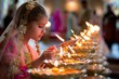 A little girl in a wedding dress is lighting candles in a religious ceremony