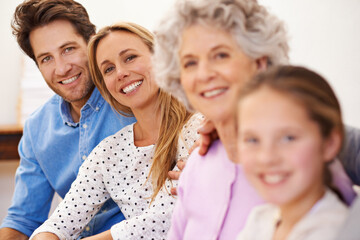 Wall Mural - Generations, portrait and family with smile, home and relax on sofa of living room for bonding. Girl, mother and father with grandma for visit with daughter or child with happiness on couch of house