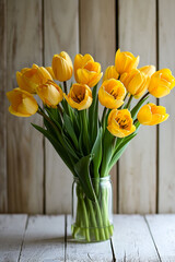 Poster - Vase full of yellow flowers with green stems sits on wooden table.