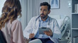 © Marta B - A doctor with a clipboard attentively listens to a patient during a consultation.